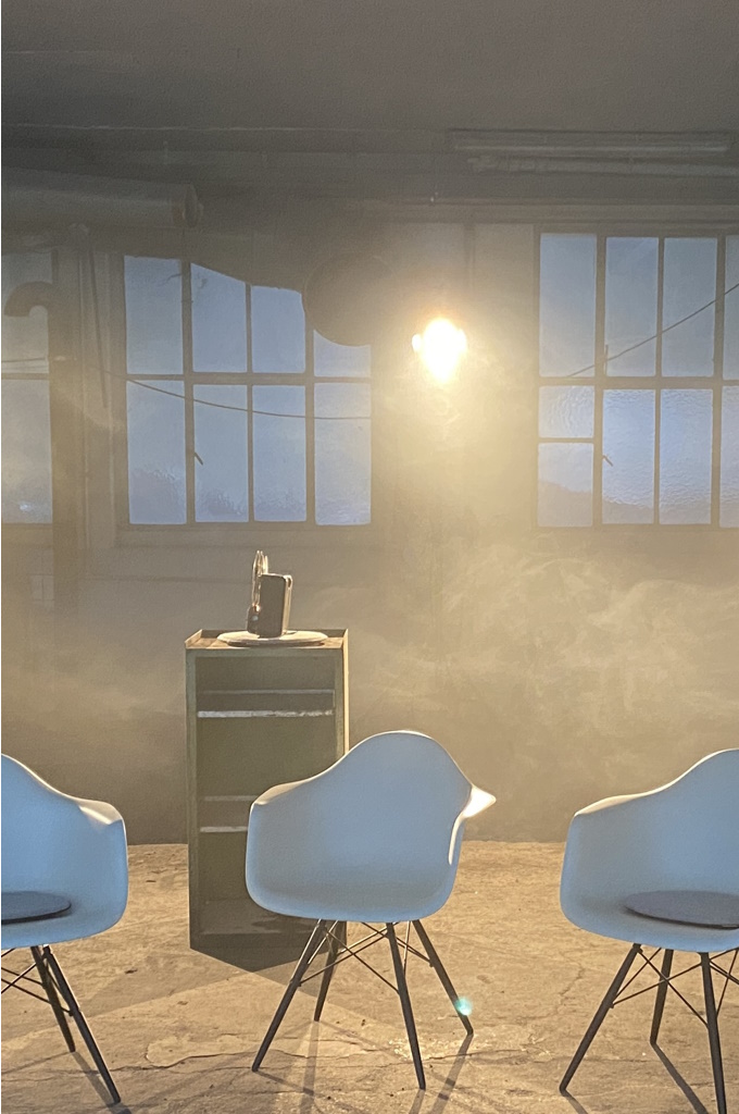drei Stühle in einer Industrieanlage licht mit Nebel